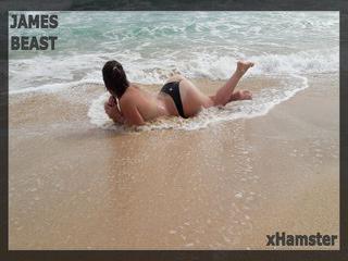 Sexy Ehefrau spielt mit Ehemann am Strand